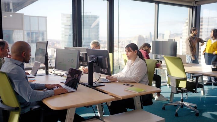 Customer experience team working in an open-plan office