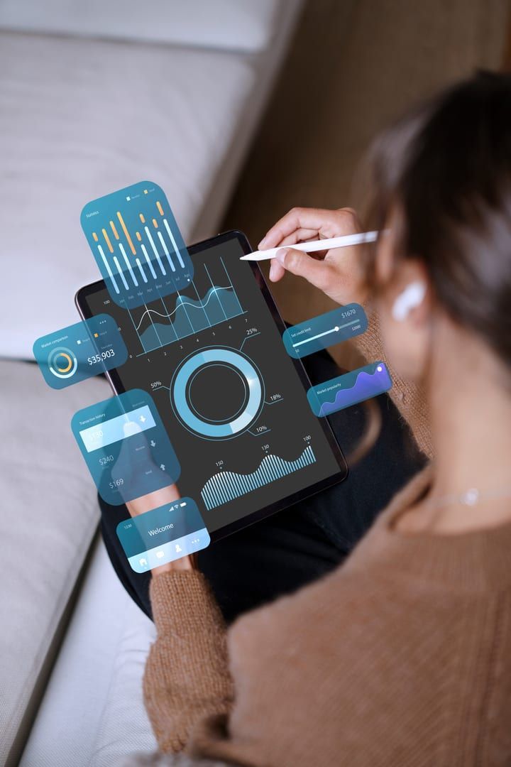 Person interacting with data dashboards on a tablet